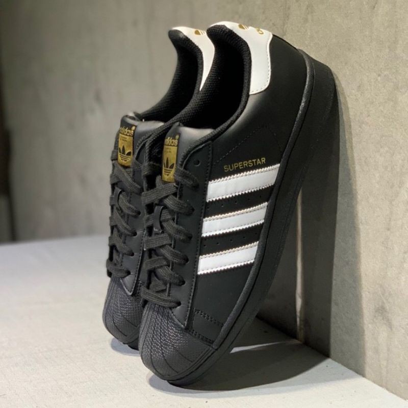 Adidas superstar black with gold outlet logo